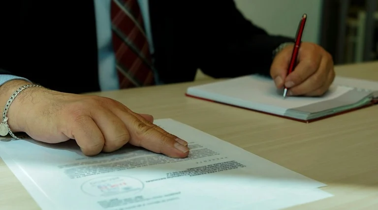 advogado para ruptura de suitability: Investidor aponta para documento contratual durante análise de adequação